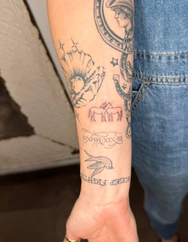 Single needle horse couple tattoo located on the inner forearm.