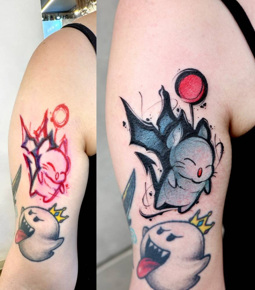 moogle tattoo in cartoon style located on the upper arm.