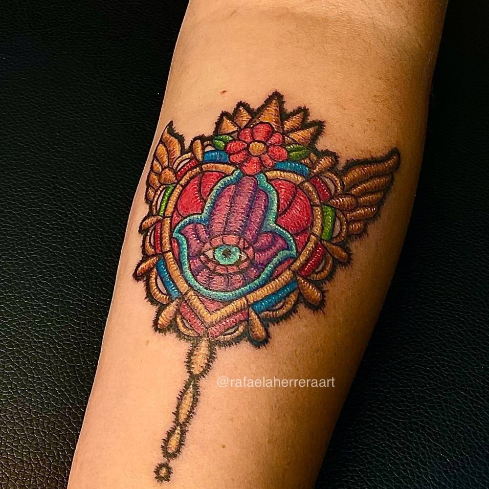 Mexican embroidery Hamsa tattoo located on the inner forearm.