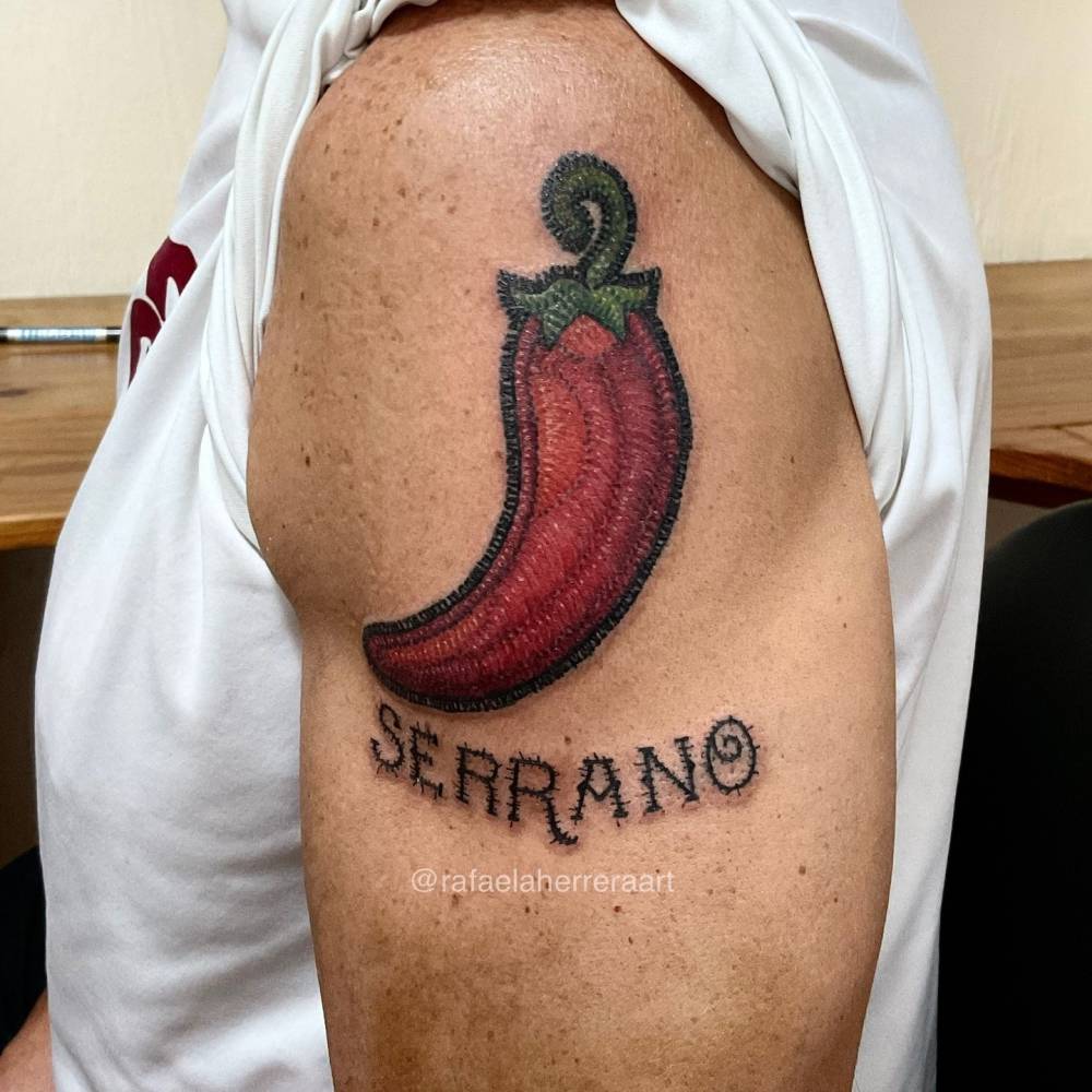 Serrano chili tattoo located on the upper arm, embroidery style.