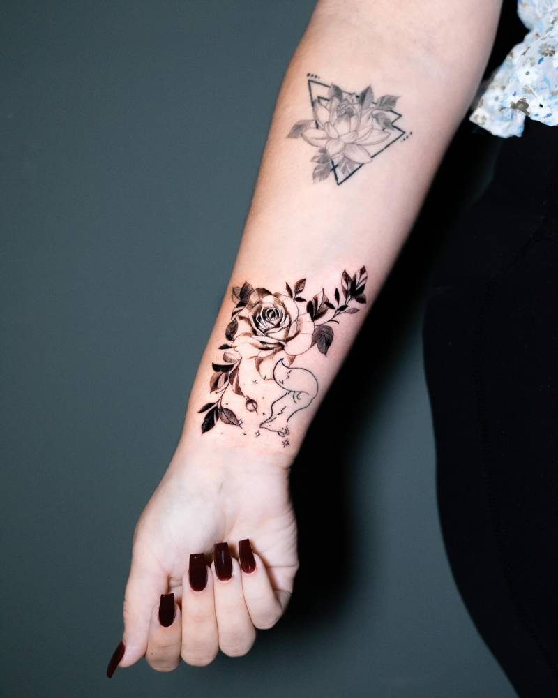 Rose head tattoo in illustrative style done on the wrist.