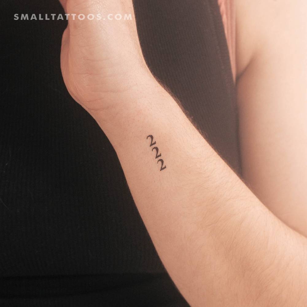 Serif font vertical "222" temporary tattoo located on the wrist.