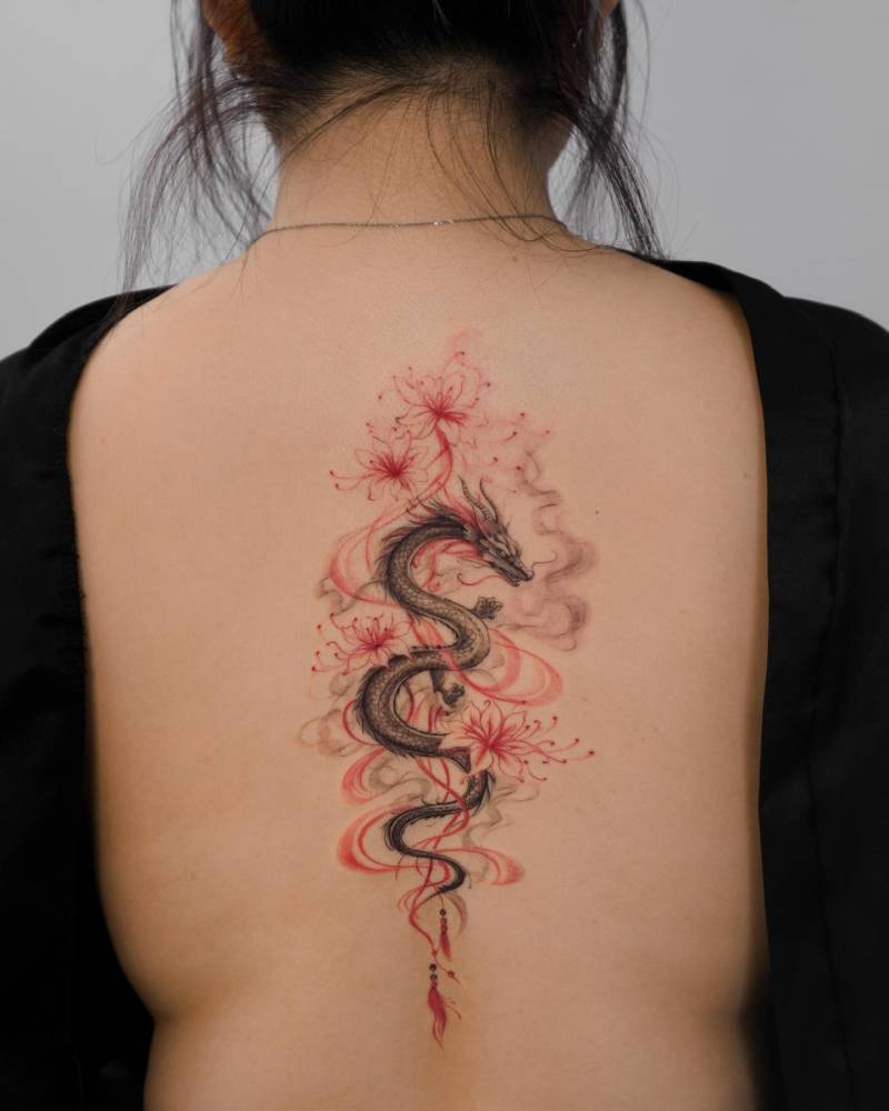 Dragon and red spider lily flowers tattooed on the back.