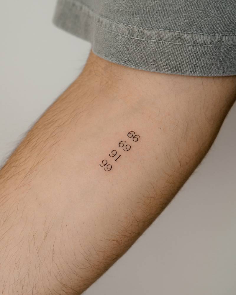 Numbers 66, 69, 91 and 99 tattooed on the inner forearm.