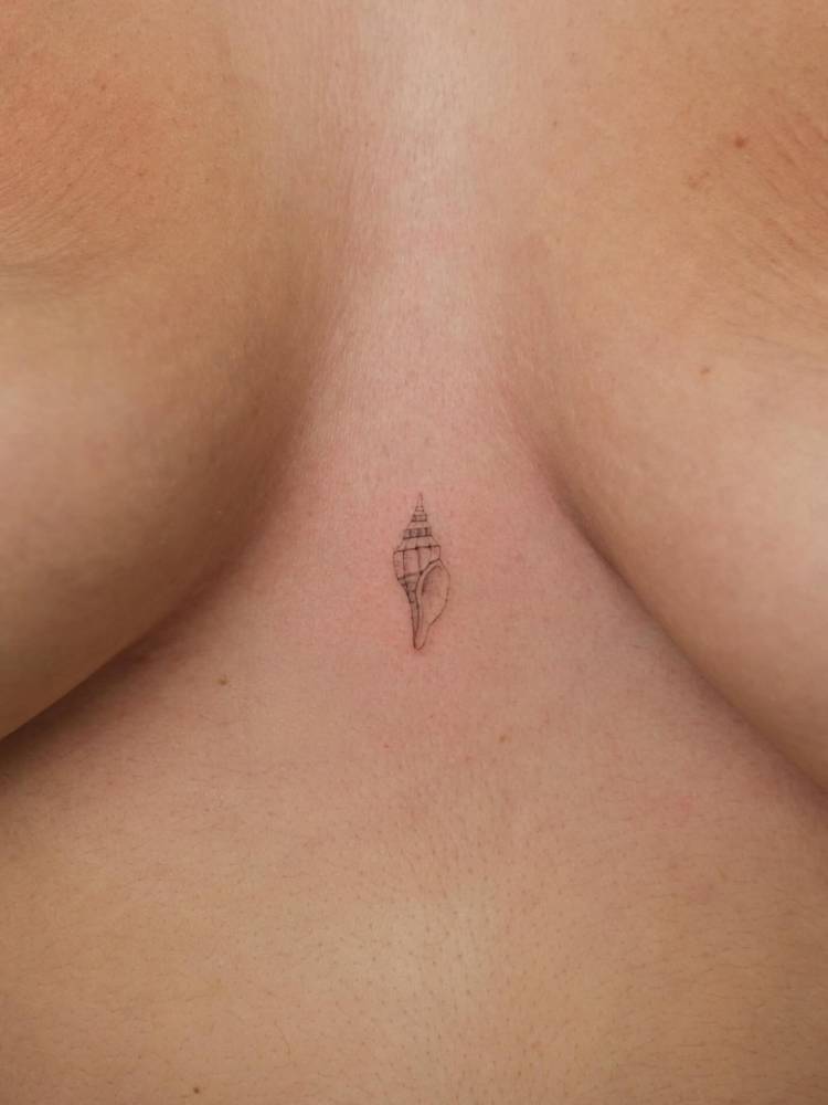 Tiny tulip shell in illustrative style placed on the sternum.