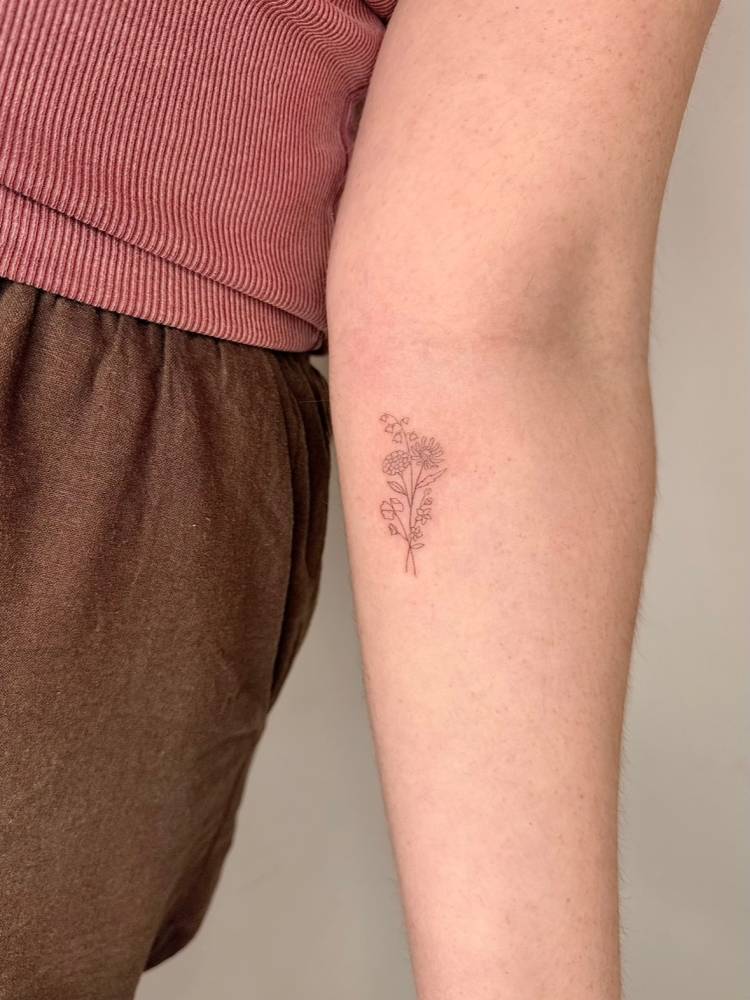 SIngle needle flower bouquet tattoo placed on the inner forearm.