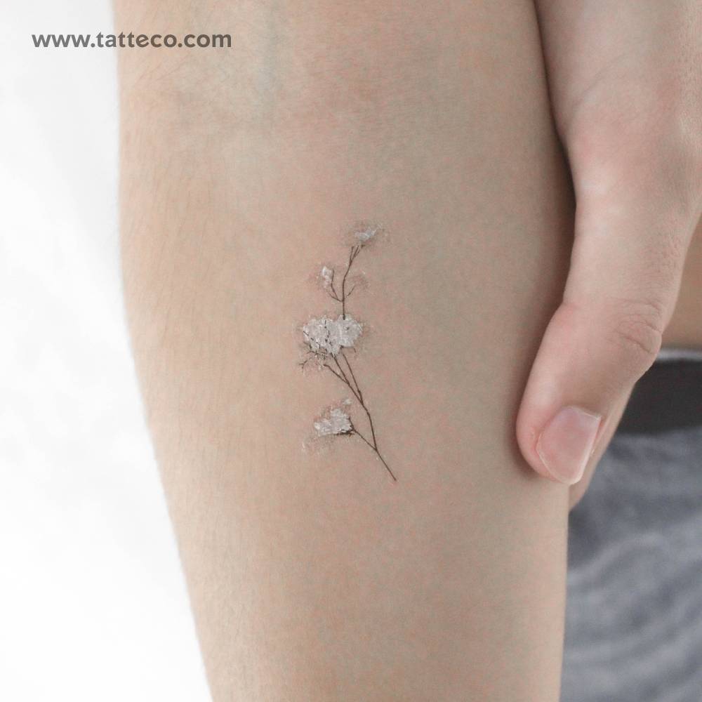 Watercolor style baby's breath temporary tattoo located on the inner forearm.