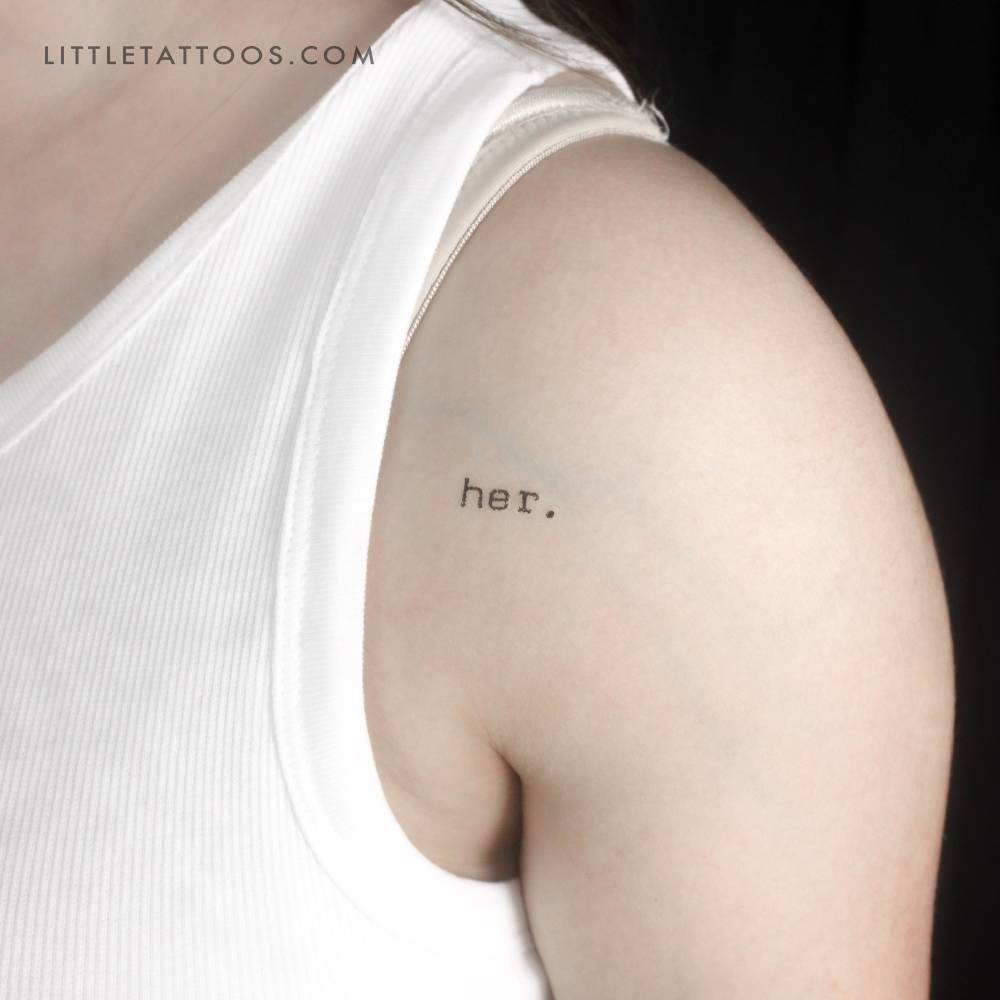 Typewriter font word 'her.' temporary tattoo located on the shoulder.
