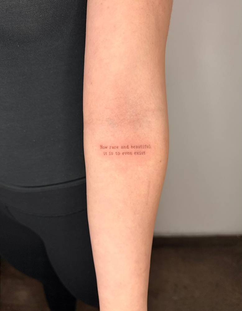 "How rare and beautiful it is to even exist" tattooed on the inner forearm.