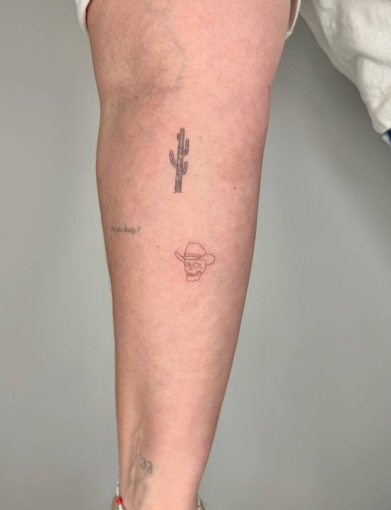 Cowboy skull tattoo in fine line style located on the inner forearm.