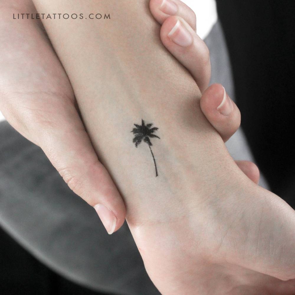 Small palm tree temporary tattoo located on the wrist.