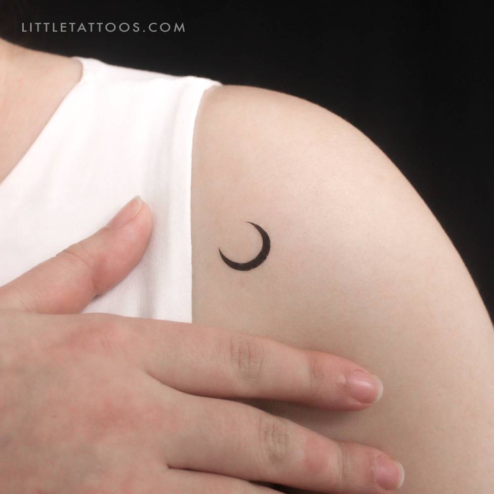 Crescent moon temporary tattoo located on the shoulder.
