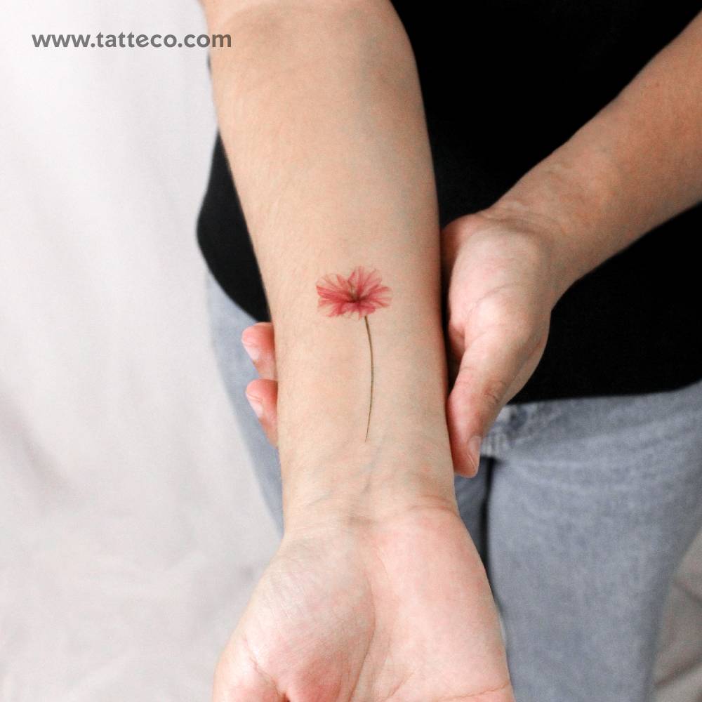Illustrative style hibiscus temporary tattoo located on the wrist.