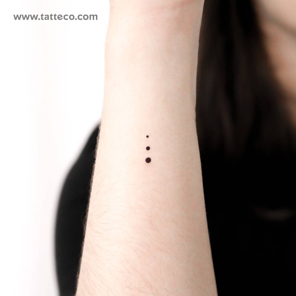 Three tiny gradual dots temporary tattoo located on the wrist.
