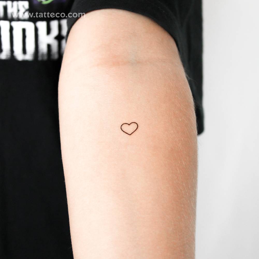 Small minimalist heart outline temporary tattoo located on the inner forearm.