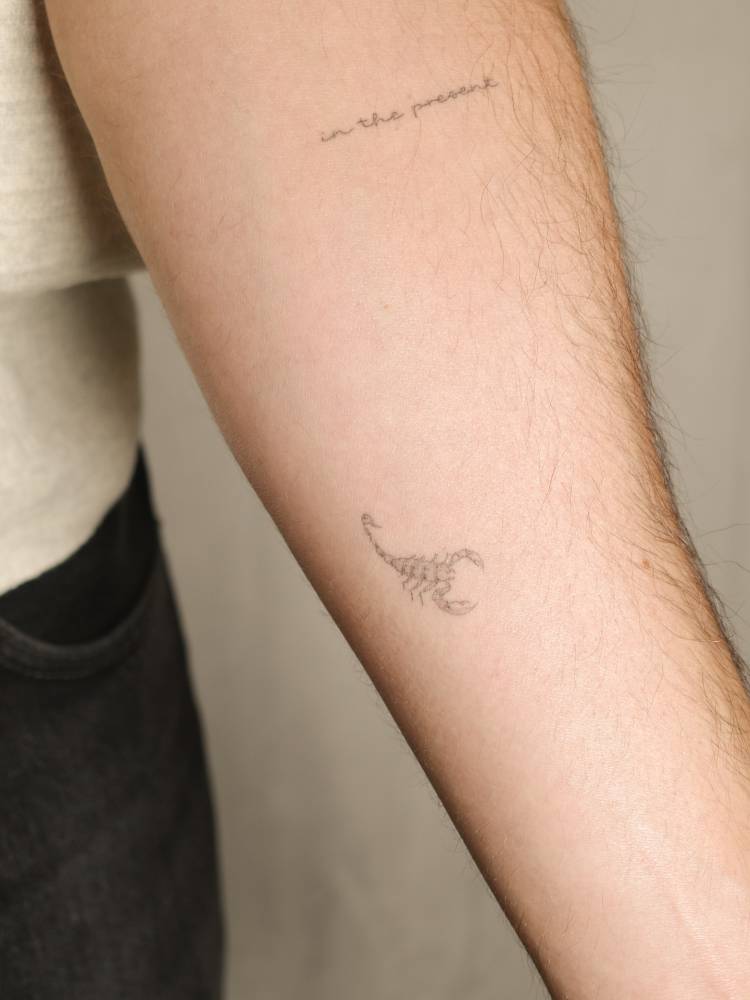 Little scorpion tattoo located on the inner forearm, fine line style.