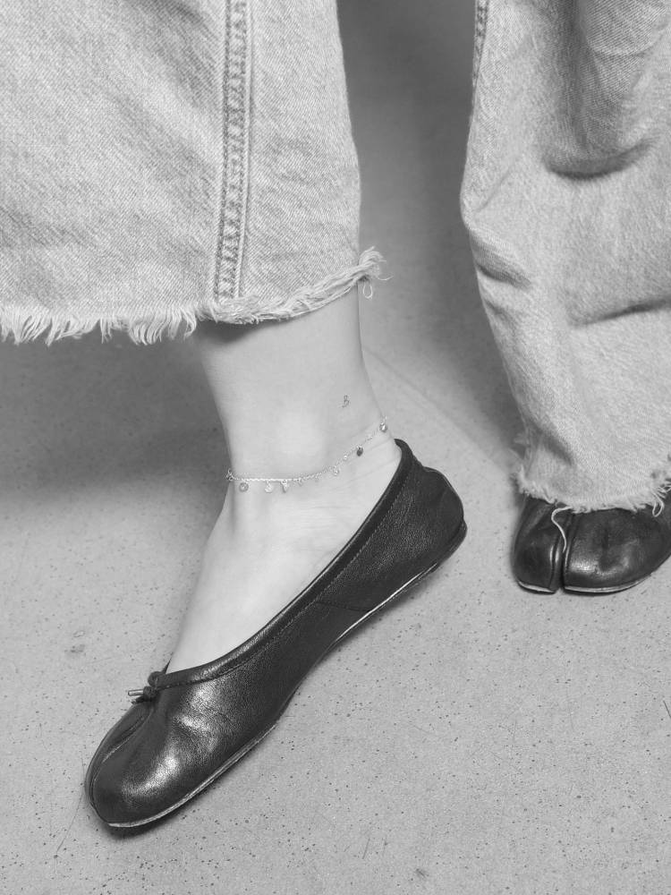 Tiny minimalist letter "B" tattoo done on the ankle.