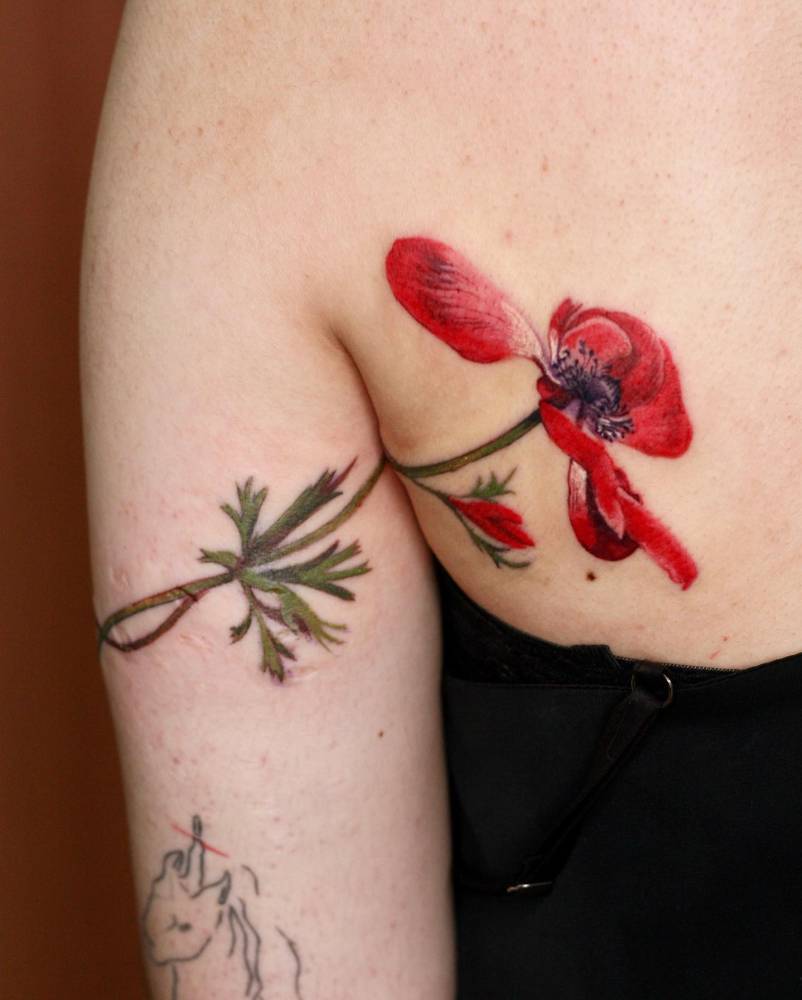 Anemone flower tattoo done in watercolor style.