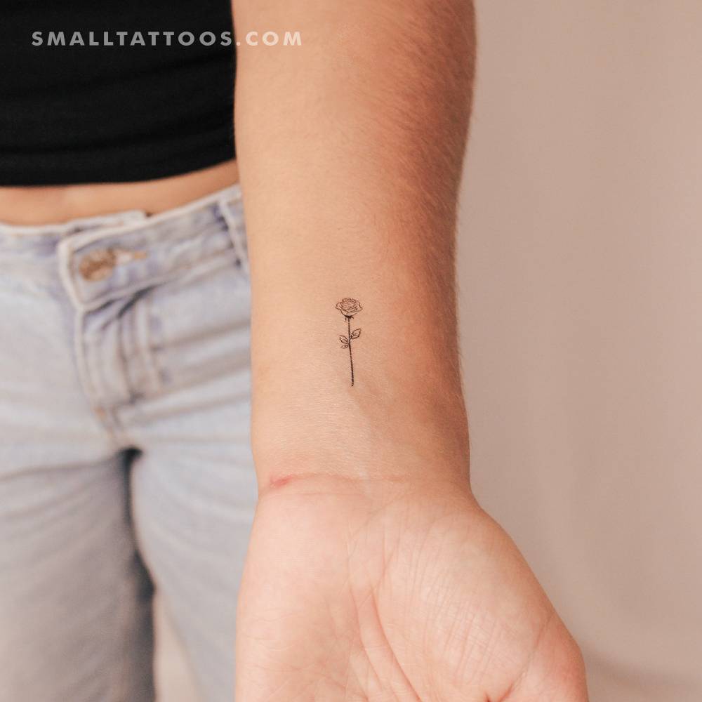Fine line rose outline temporary tattoo located on the wrist.