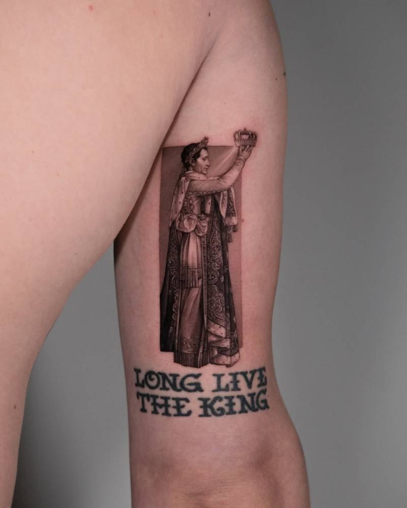 Micro-realistic style Napoleon tattoo located on the tricep.