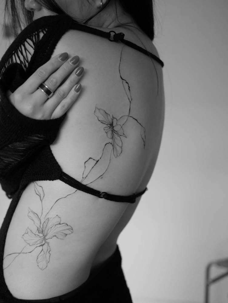 Botanical concept tattoo located on the back.