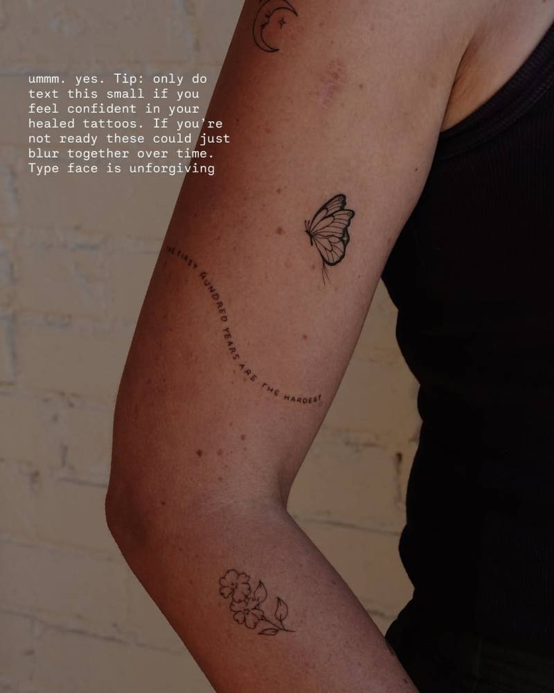 "The first hundred years are the hardest" and butterfly tattoos located on the upper arm.