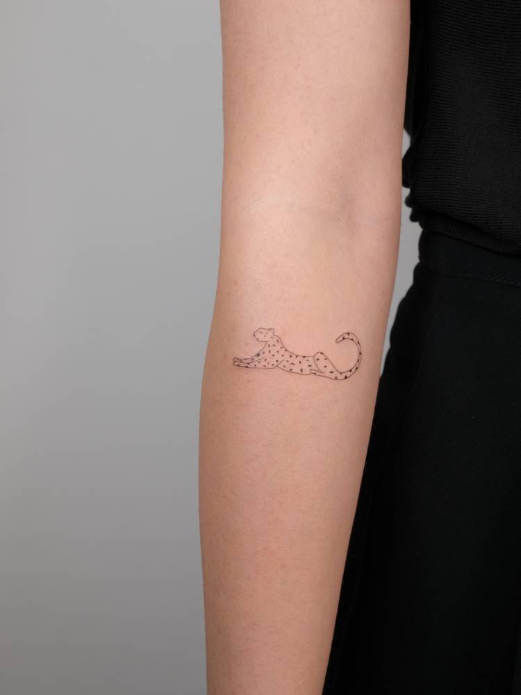 Little leopard tattoo located on the inner forearm.