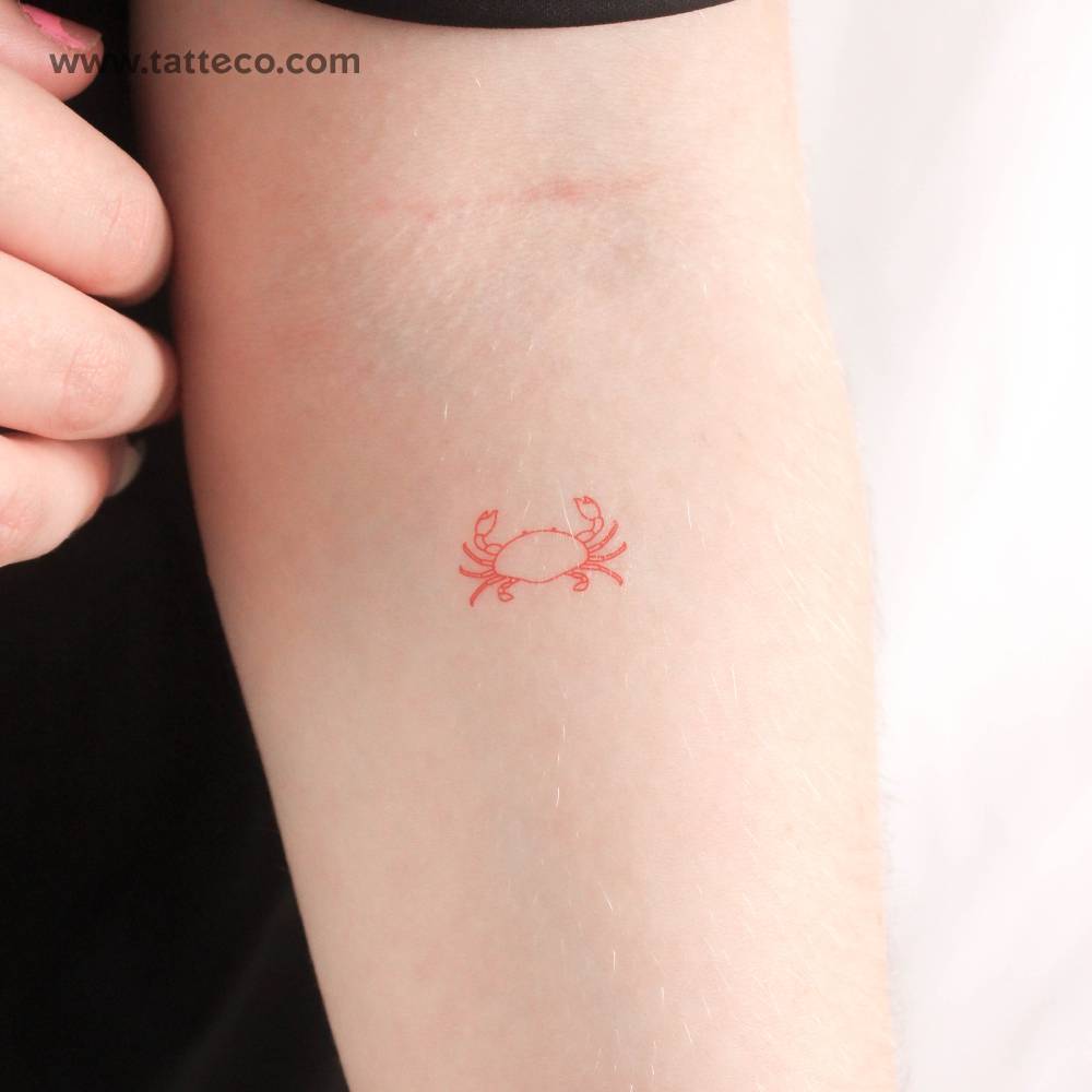 Fine line style red crab temporary tattoo located on the inner forearm.
