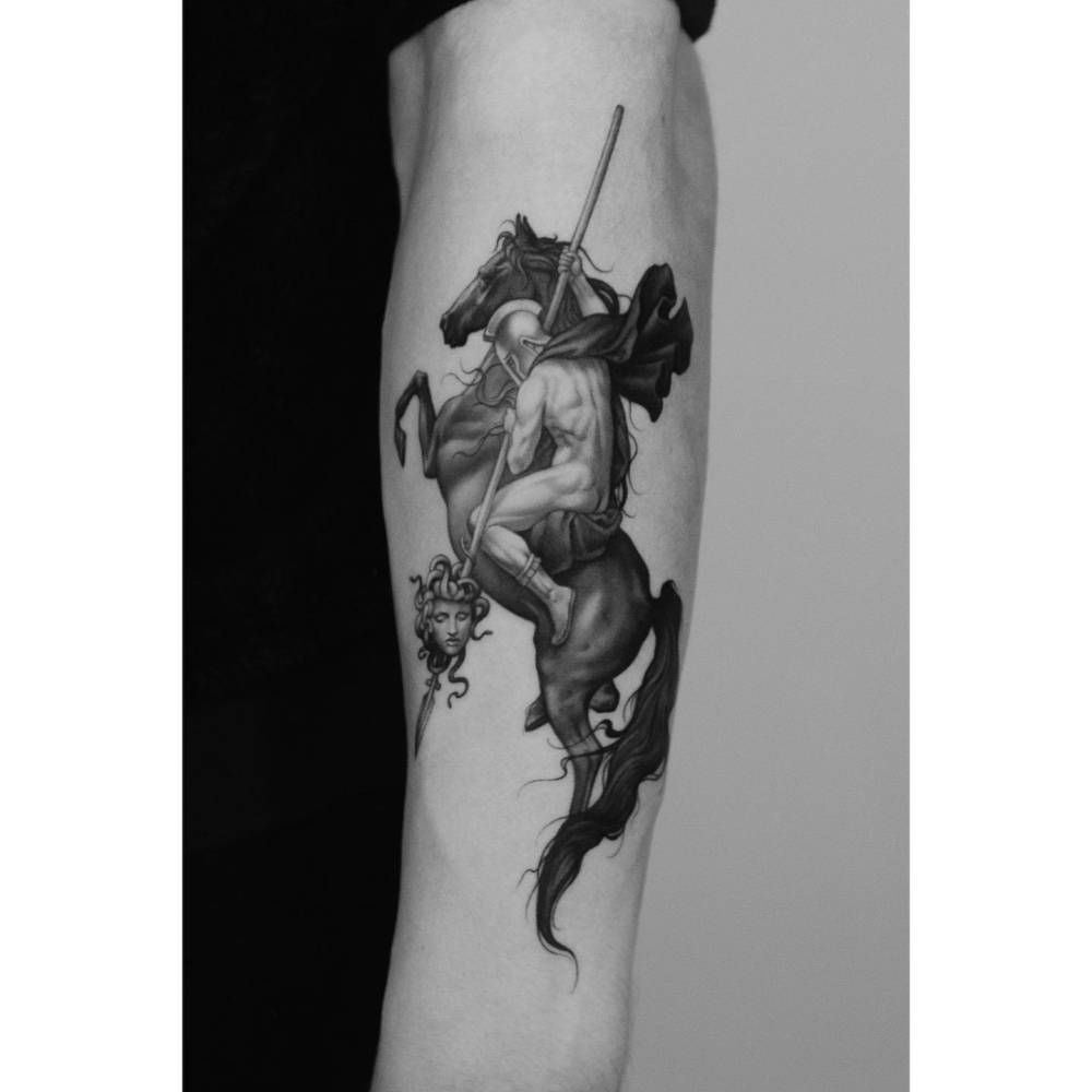 Perseus and the head of Medusa tattoo located on the forearm, micro-realistic style.