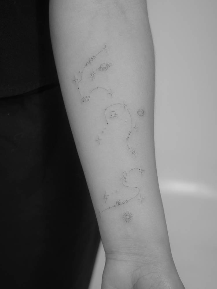 Aquarius, Libra and Leo constellations tattooed on the inner forearm.