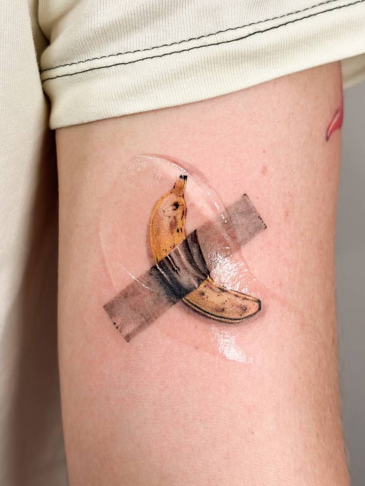 Maurizio Cattelan's artwork tattooed on the upper arm.