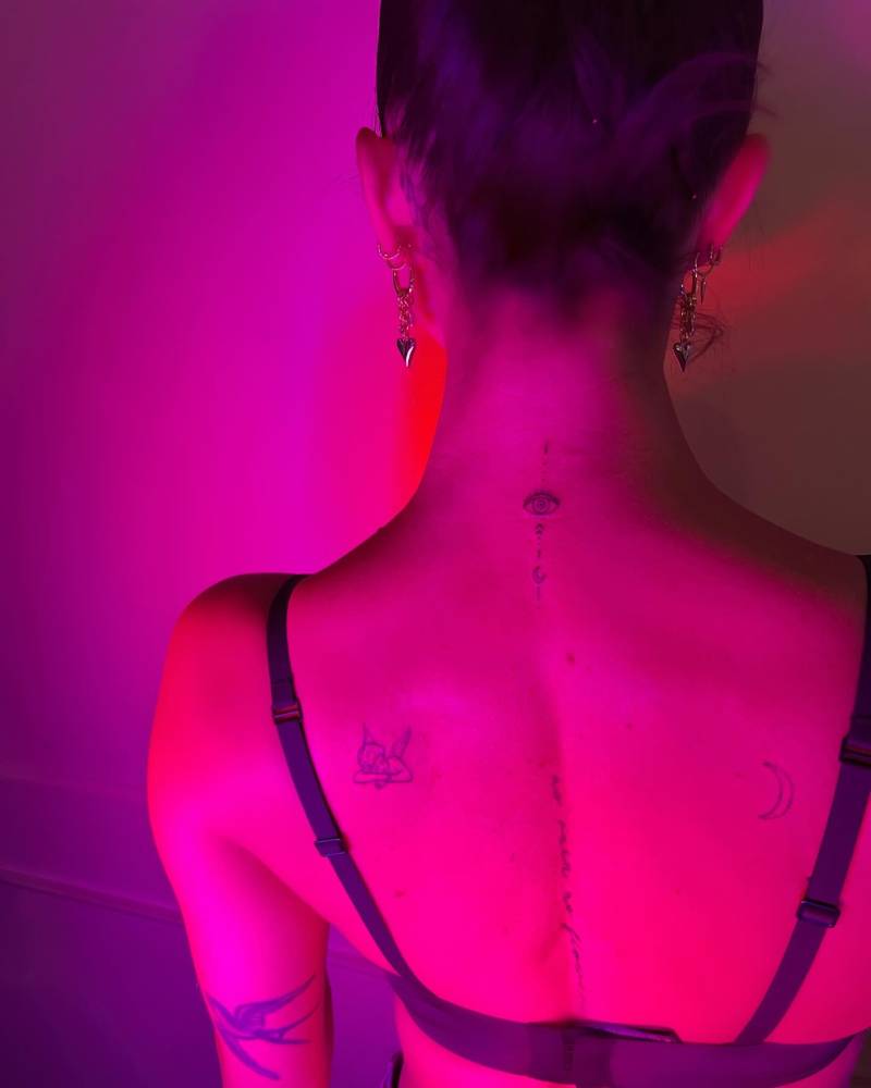 Ornamental evil eye tattoo located on the upper back.