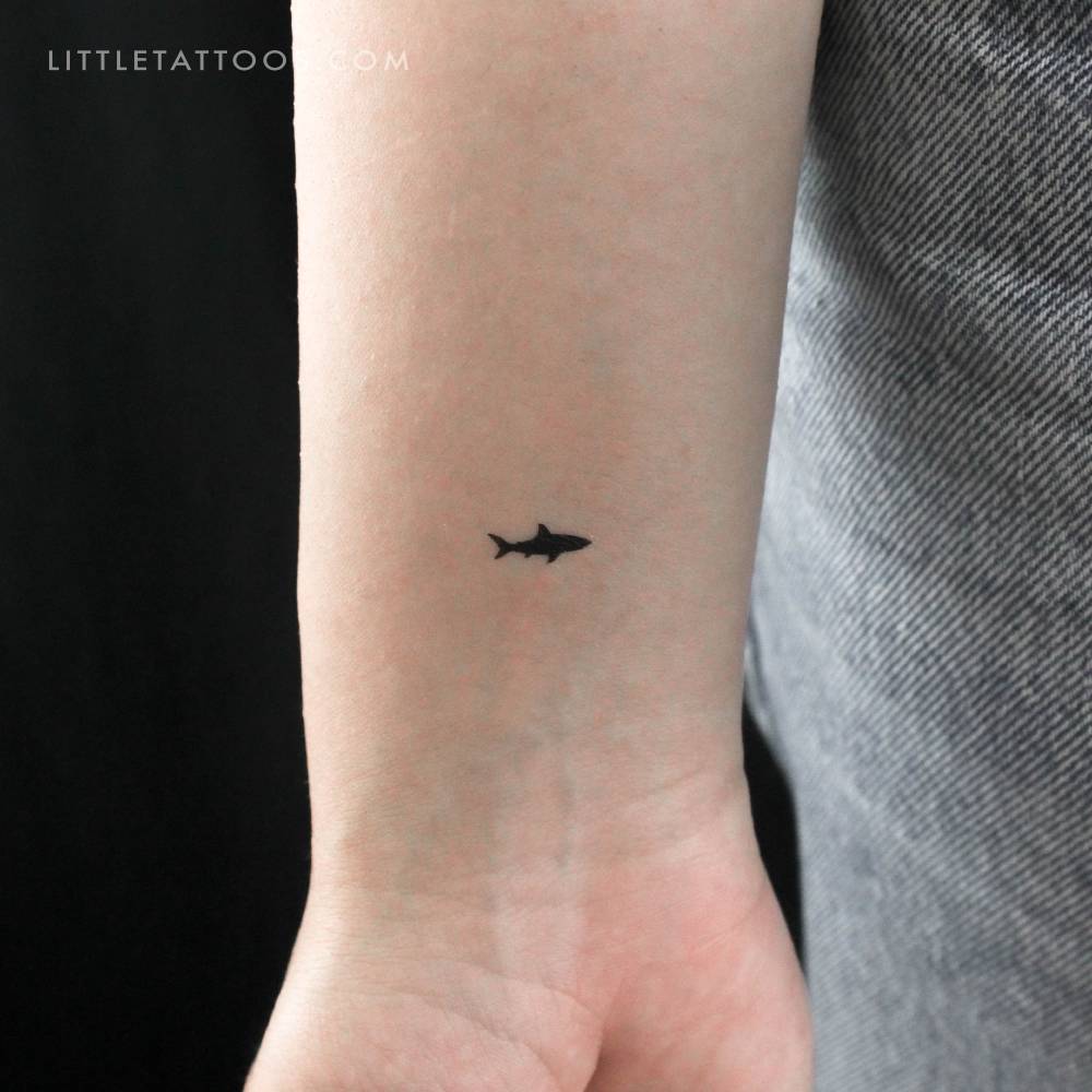 Tiny shark temporary tattoo placed on the wrist.