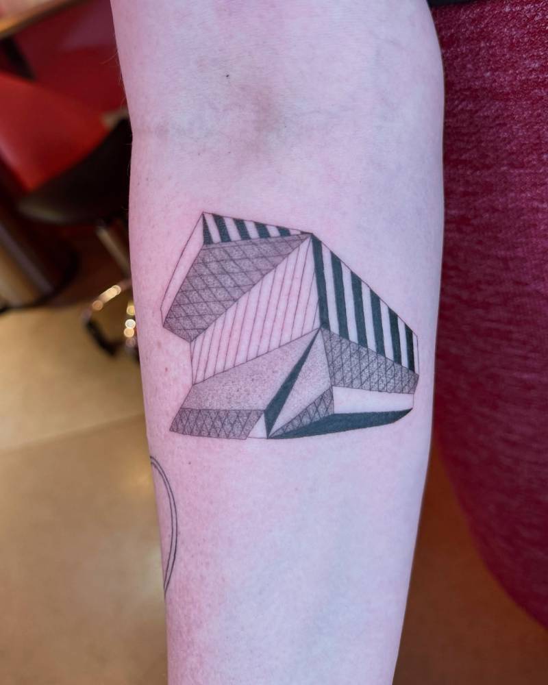 Seattle Central Library tattoo located on the inner forearm.