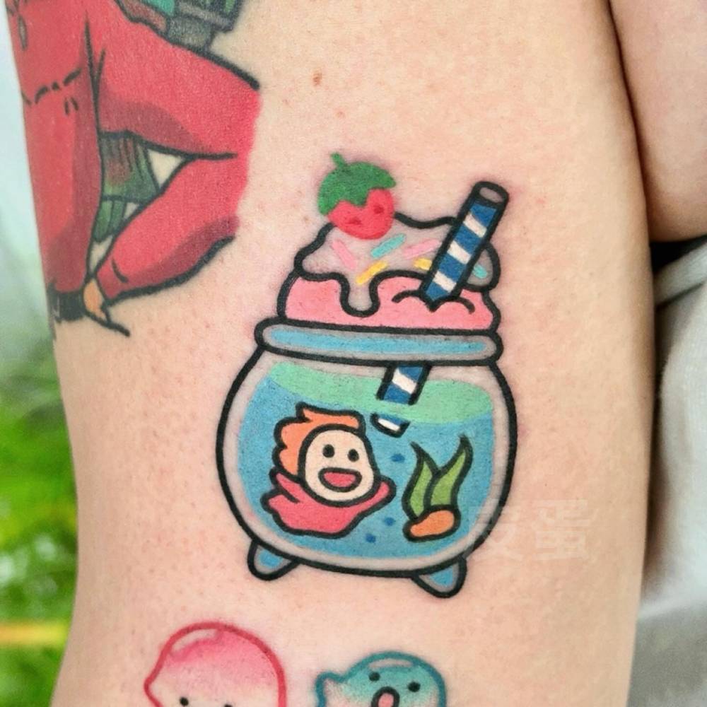 Fish bowl milkshake tattoo located on the tricep.