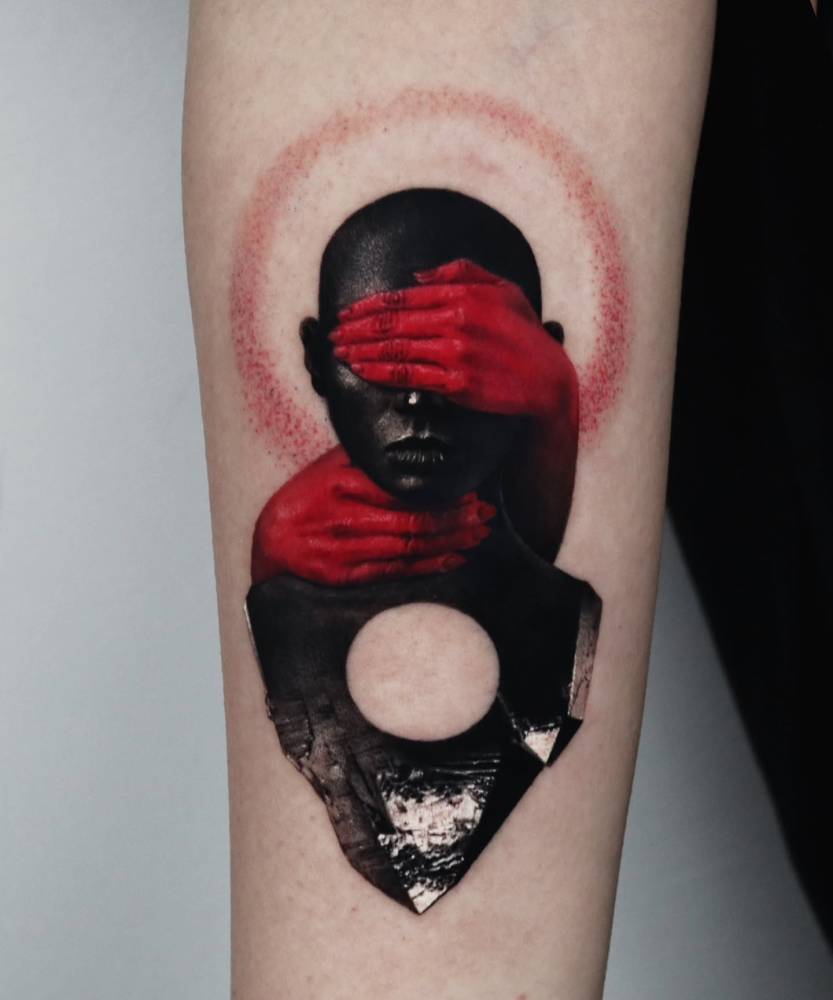 Surrealistic design tattooed on the inner forearm.
