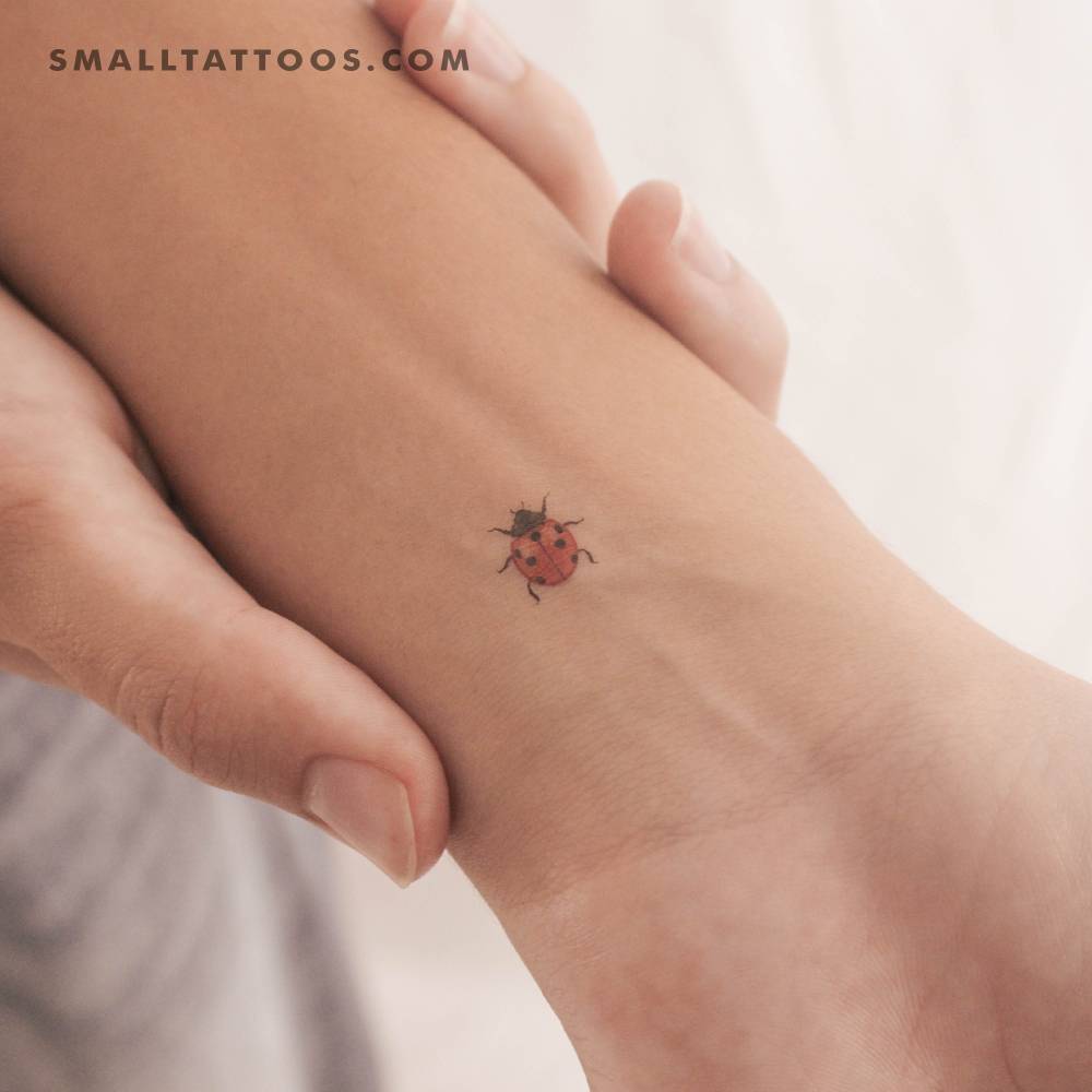 Tiny ladybird temporary tattoo located on the wrist.