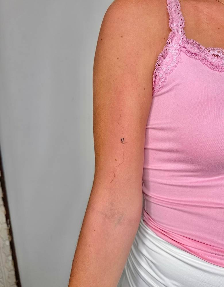 Minimalistic design tattooed on the bicep.