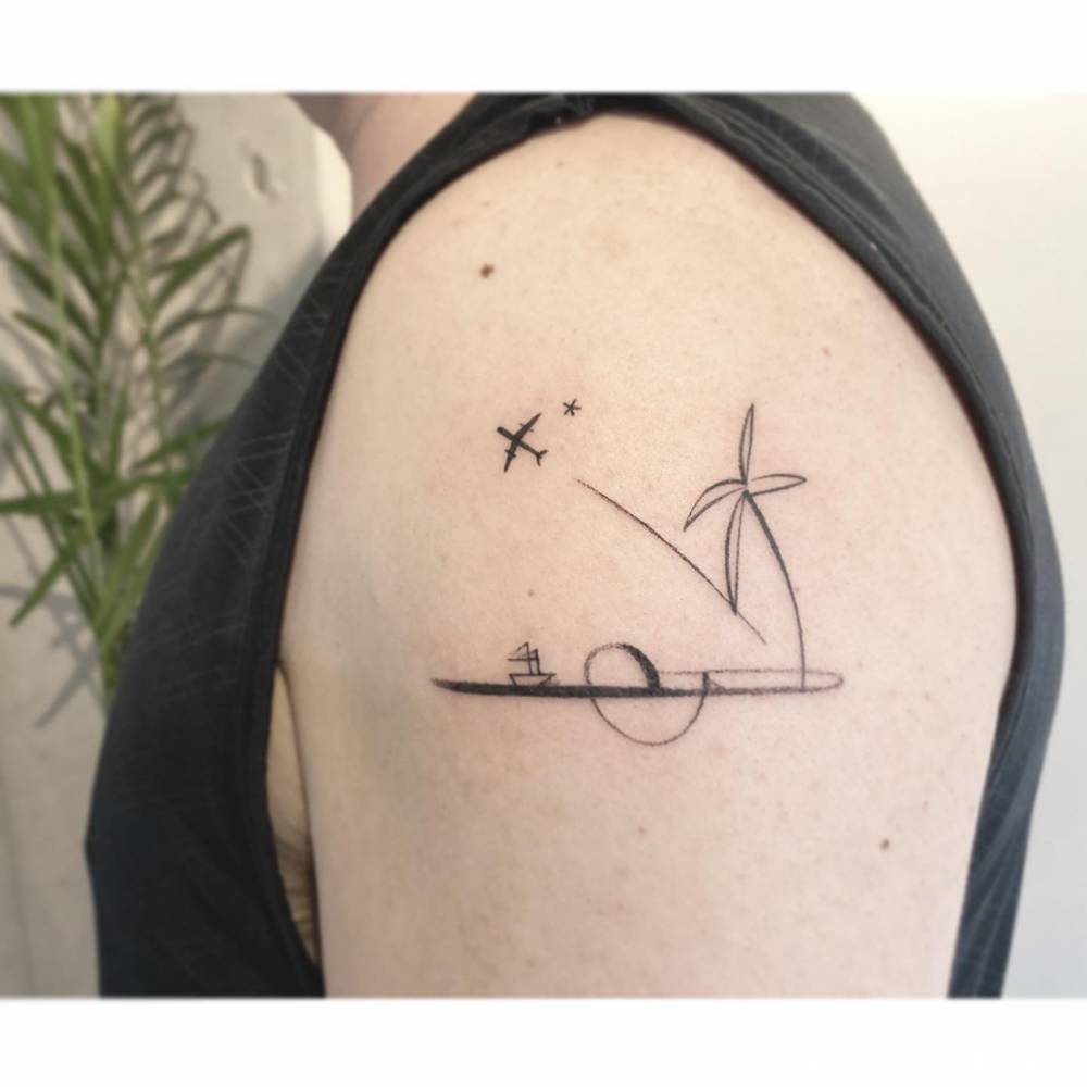 Airplane and sea tattoo located on the upper arm.