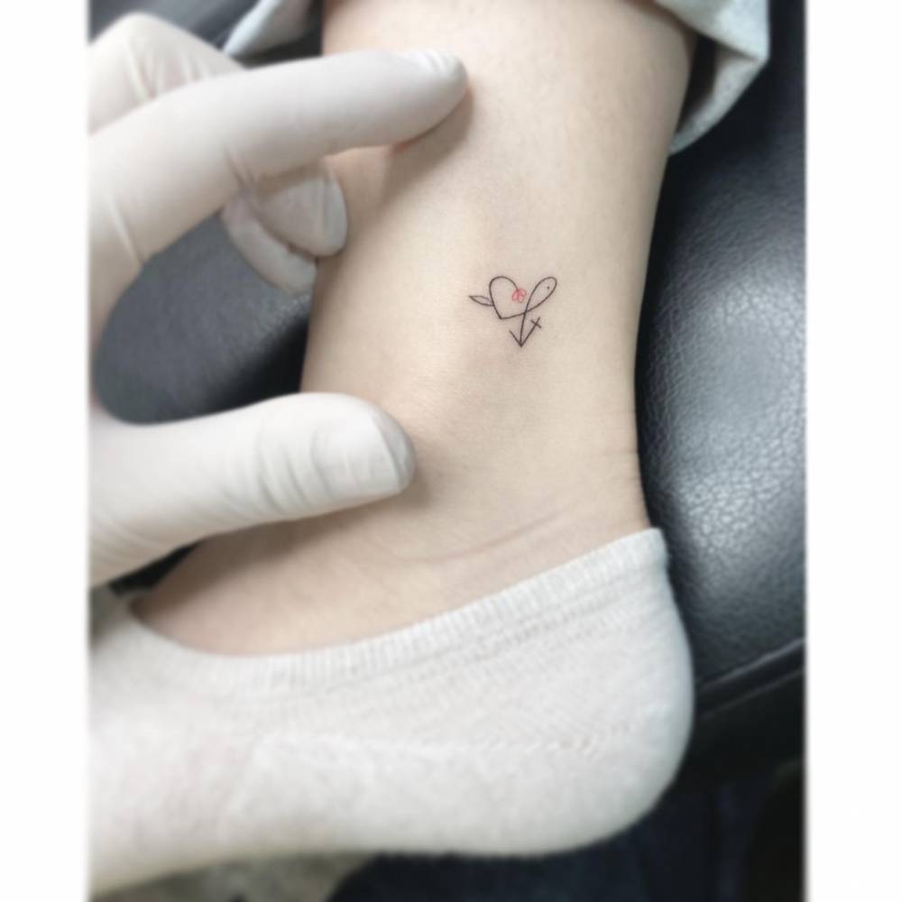 Jesus fish, flower heart and cross tattoo in minimalistic style.