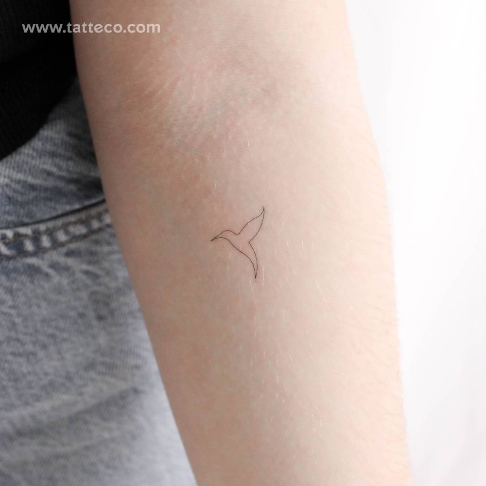 Small fine line hummingbird temporary tattoo located on the inner forearm.