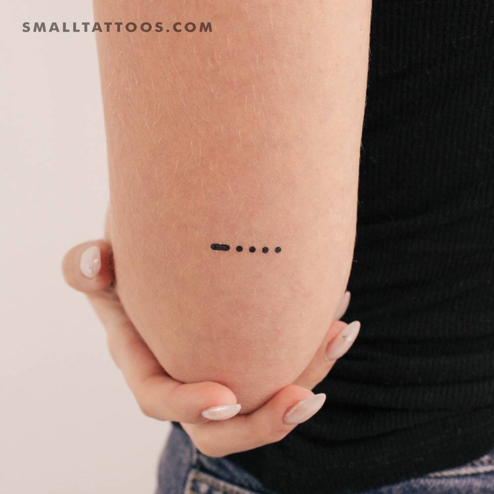 Morse code 6 temporary tattoo located on the tricep.