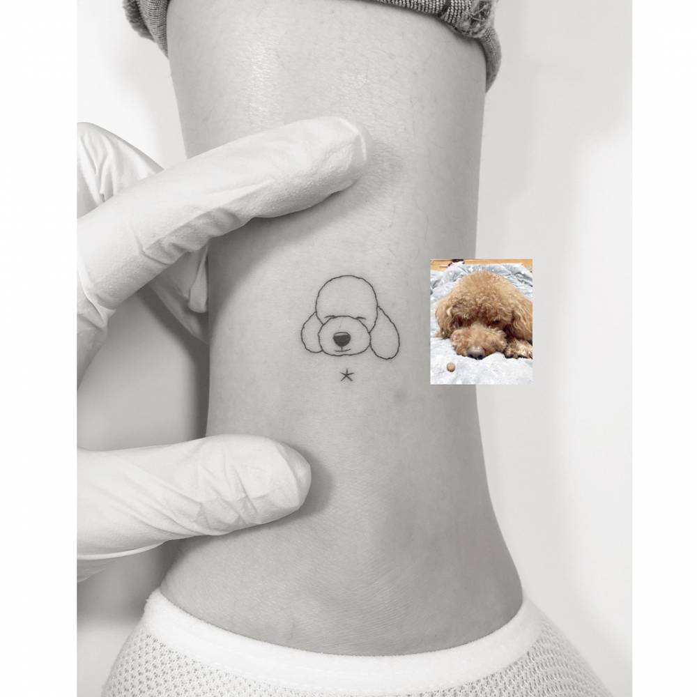 Minimalistic style Poodle portrait tattoo located on the ankle.