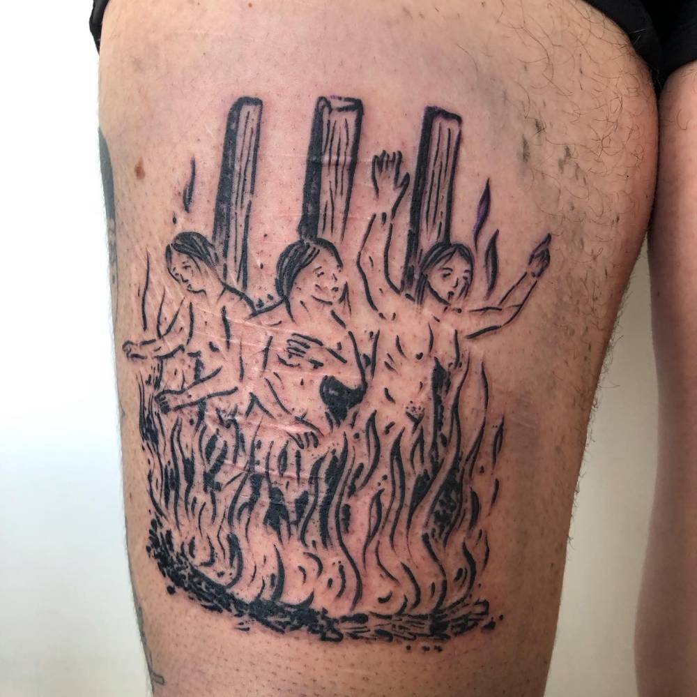 Burning witches tattooed on the thigh, engraving style.