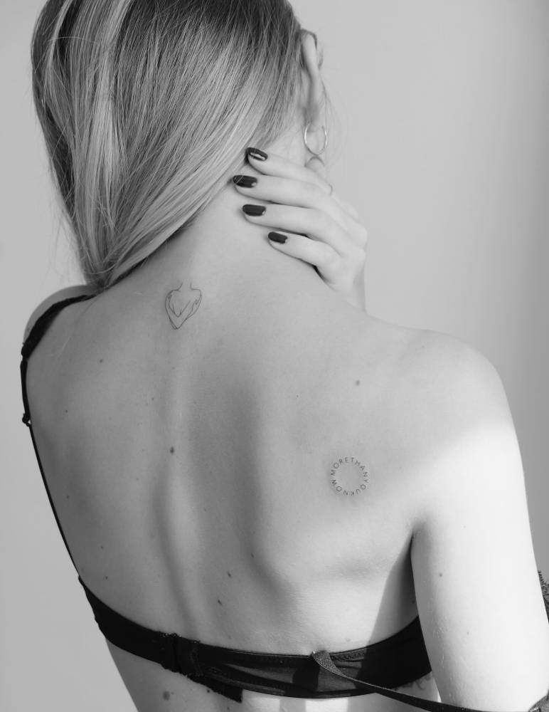 Fine line style self hug and "more than you know" lettering circle tattoos.