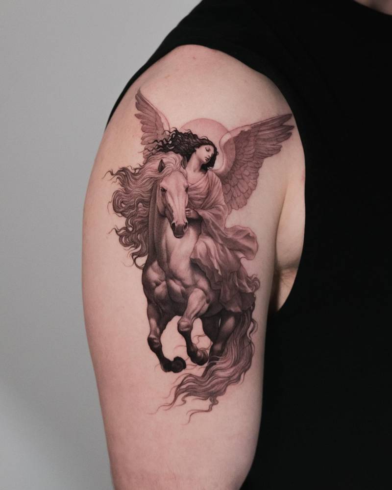 Horse and angel tattoo in classical style located on the upper arm.
