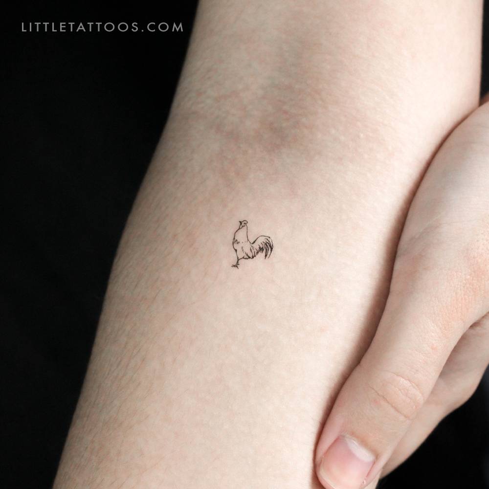 Tiny fine line rooster temporary tattoo placed on the inner forearm.