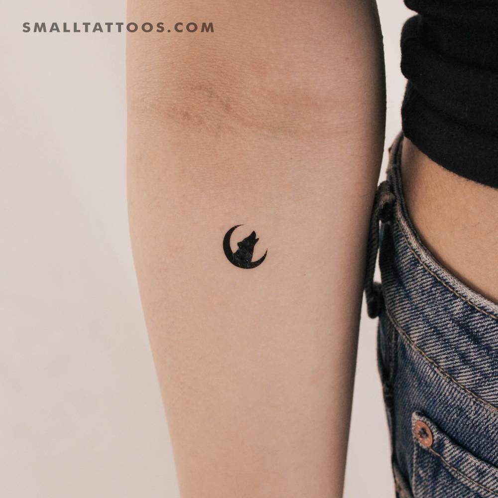 Wolf and moon temporary tattoo located on the inner forearm.