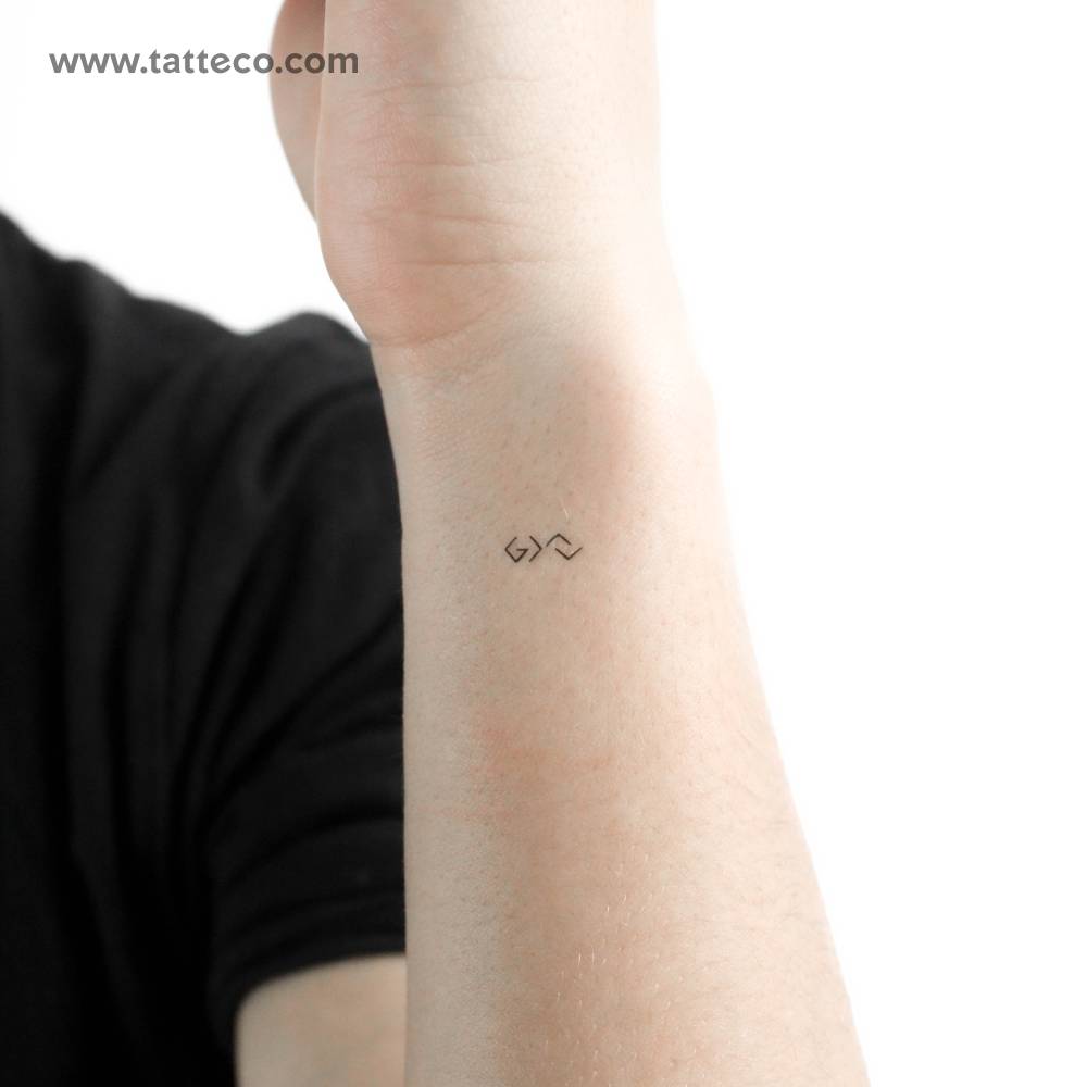 Tiny "God is greater than the highs and lows" temporary tattoo.