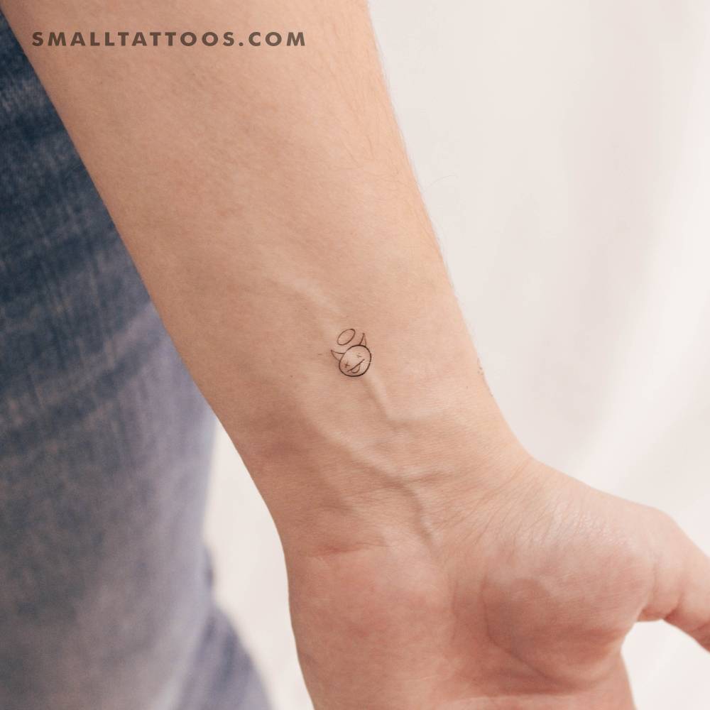 Tiny minimalistic devil temporary tattoo done on the wrist.